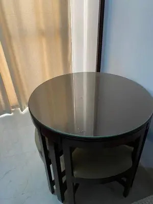 a table and a chair with a glass top at Taiba View Studio in Hurghada