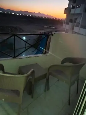 a balcony with a view of the ocean at sunset at Taiba View Studio in Hurghada