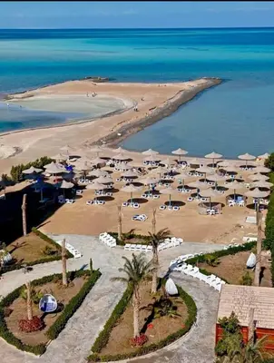 an aerial view of a beach with palm trees and umbrellas at Hurghada Fiesta Resort Studio 232 Beach in Hurghada