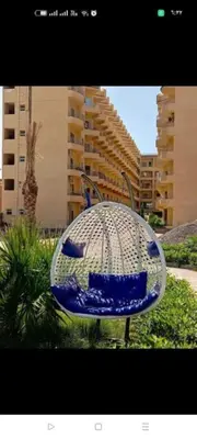 a blue and white chair in front of a building at Hurghada Fiesta Resort Studio 232 Beach in Hurghada