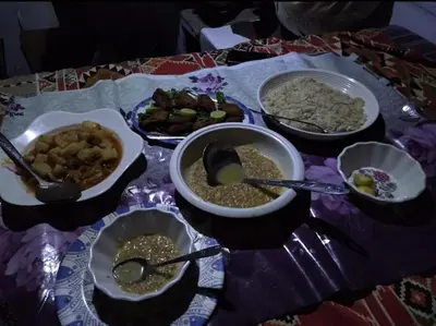 a table with several bowls of food on a table at Sunset and Sand Felucca Life on the Nile in Jazīrat Aswān
