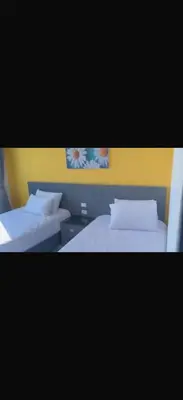 two beds with white pillows in a room at 1 bedroom apartment hurghada in Hurghada