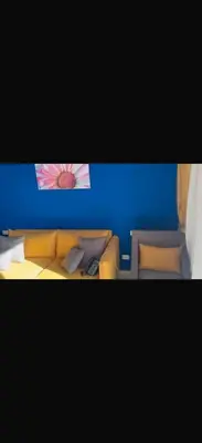 a room with a couch and a blue wall at 1 bedroom apartment hurghada in Hurghada