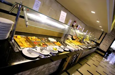 a buffet line with many plates of food at Minaland Beach Resort & Aquapark in Hurghada