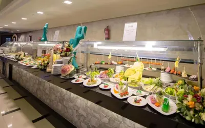 a buffet line with many plates of food at Minaland Beach Resort & Aquapark in Hurghada