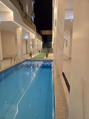a large swimming pool in a large building at Beachfront Studio Hurghada in Hurghada