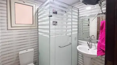 a bathroom with a toilet and a sink at Hurghada HUB Resort in Hurghada