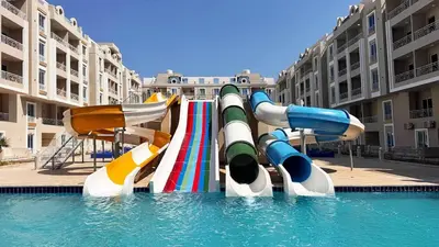 a water slide in the middle of a swimming pool at Hurghada HUB Resort in Hurghada