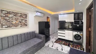 a living room with a couch and a kitchen at Hurghada HUB Resort in Hurghada