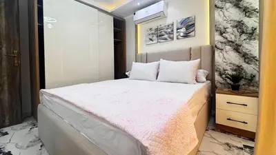 a bedroom with a large bed with a pink blanket at Hurghada HUB Resort in Hurghada