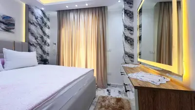 a bedroom with a bed and a dresser and a mirror at Hurghada HUB Resort in Hurghada