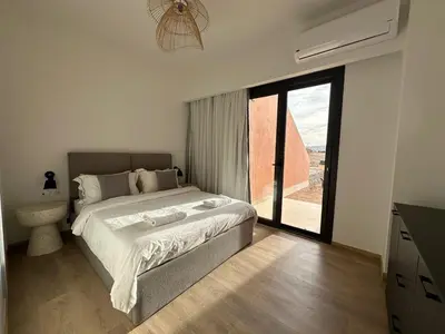 a bedroom with a large bed and a large window at Kamaran El Gouna - 1 bed ground in Hurghada
