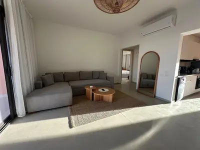 a living room with a couch and a table at Kamaran El Gouna - 1 bed ground in Hurghada