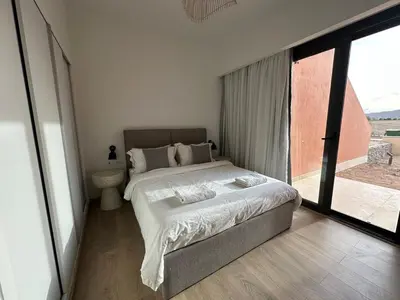 a bedroom with a bed and a large window at Kamaran El Gouna - 1 bed ground in Hurghada