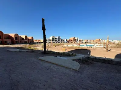 a park with a bench in the middle of a city at Kamaran El Gouna - 1 bed ground in Hurghada