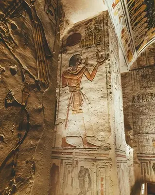 a wall with paintings on it in a cave at Al Wadi Hotel in Al Aqālitah