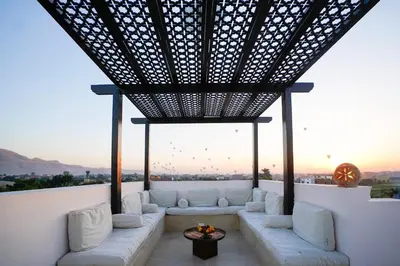 a living room with a couch and a table at Al Wadi Hotel in Al Aqālitah