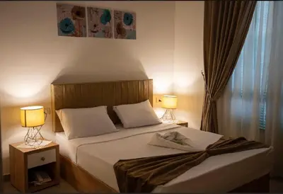 a bedroom with a large bed with two lamps at الاقصر امتداد ش التليفزيون in Luxor