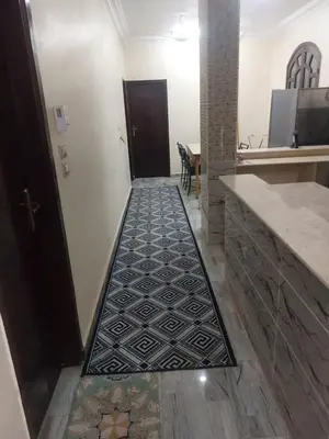 a hallway with a door and a tile floor at الاقصر امتداد ش التليفزيون in Luxor