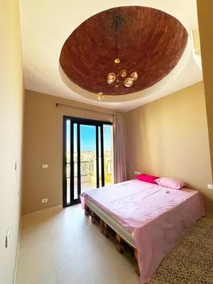 a bedroom with a large bed with a large ceiling at Hurghada Apartment Makadi Lagon & Swimming Pools Free in Hurghada