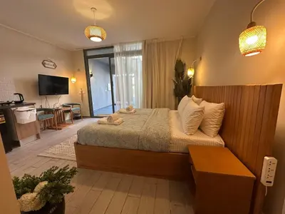a bedroom with a large bed and a television at Bali Gouna 1 bed - heated pool in Hurghada