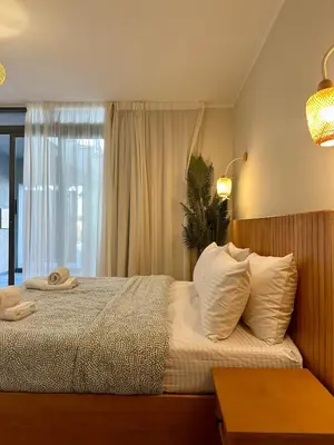 a bedroom with a bed with white sheets and a window at Bali Gouna 1 bed - heated pool in Hurghada