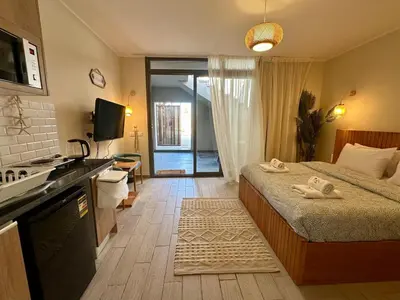 a bedroom with a bed and a kitchen with a television at Bali Gouna 1 bed - heated pool in Hurghada