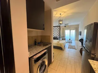 a kitchen with a sink and a washer at Aldau Maxico in Hurghada