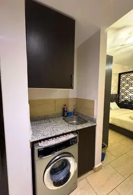 a kitchen with a washing machine and a sink at Aldau Maxico in Hurghada