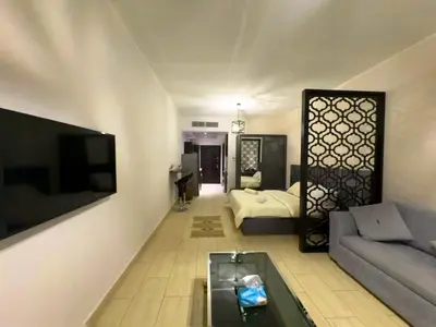 a living room with a couch and a tv at Aldau Maxico in Hurghada