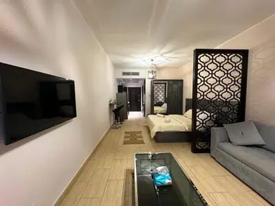 a living room with a couch and a tv at Aldau Maxico in Hurghada