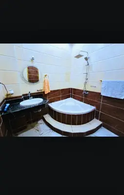 a bathroom with two sinks and a bath tub at Nile palace apartment in Luxor