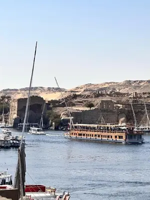 two boats are docked on the water in a river at Escaleeh Dahabiya Tranquil sailing in Jazīrat Suhayl