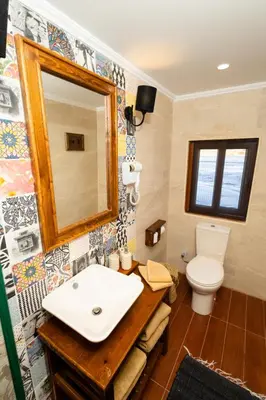 a bathroom with a sink and a mirror and a toilet at Escaleeh Dahabiya Tranquil sailing in Jazīrat Suhayl