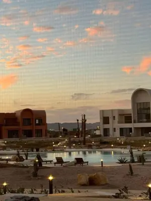 a building with a pool in the middle of a city at Luxurious 3Bd Living Awaits in El Gouna in Hurghada