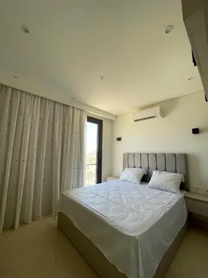 a bedroom with a large white bed with a window at Luxurious 3Bd Living Awaits in El Gouna in Hurghada