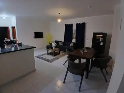 a kitchen and living room with a table and a couch at Yulla apartment in Hurghada