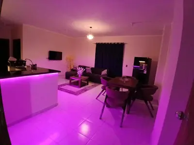 a living room with purple lighting in a living room at Yulla apartment in Hurghada