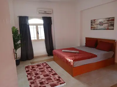 a bedroom with a bed and a window at Villa yulla in Hurghada