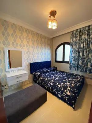 a bedroom with a bed and a tv in it at Palm View Paradise-Downtown Hurghada in Hurghada