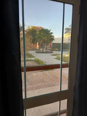 a window with a view of a courtyard at Cozy Villa in Hurghada
