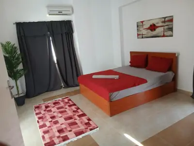 a bedroom with a bed with red pillows at Cozy Villa in Hurghada