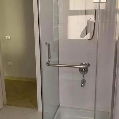 a shower with a glass door in a bathroom at West Side B 1 2 in Hurghada