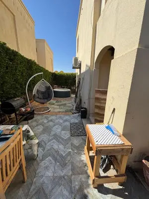 a patio with a table and a bench next to a building at The Retreat in Hurghada