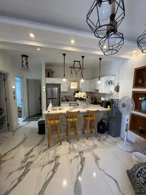a kitchen with a marble floor and a table with chairs at The Retreat in Hurghada