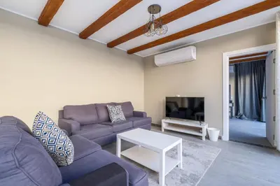 a living room with a couch and a table at Luxury 2BR Bali • Heated Pool in Hurghada