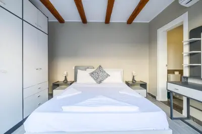 a bedroom with a large white bed and two night stands at Luxury 2BR Bali • Heated Pool in Hurghada