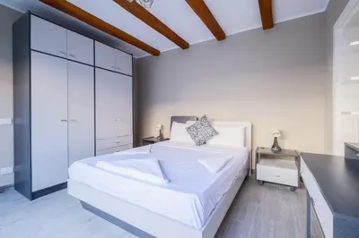 a white bedroom with a large white bed and a counter at Luxury 2BR Bali • Heated Pool in Hurghada