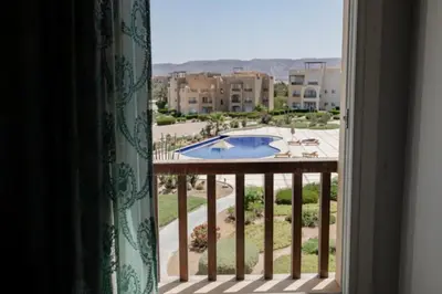 a view of a pool from a window at Exquisite 2 Bdr Apartment Waterside in Hurghada