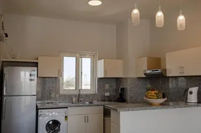 a kitchen with a refrigerator and a dishwasher at Exquisite 2 Bdr Apartment Waterside in Hurghada